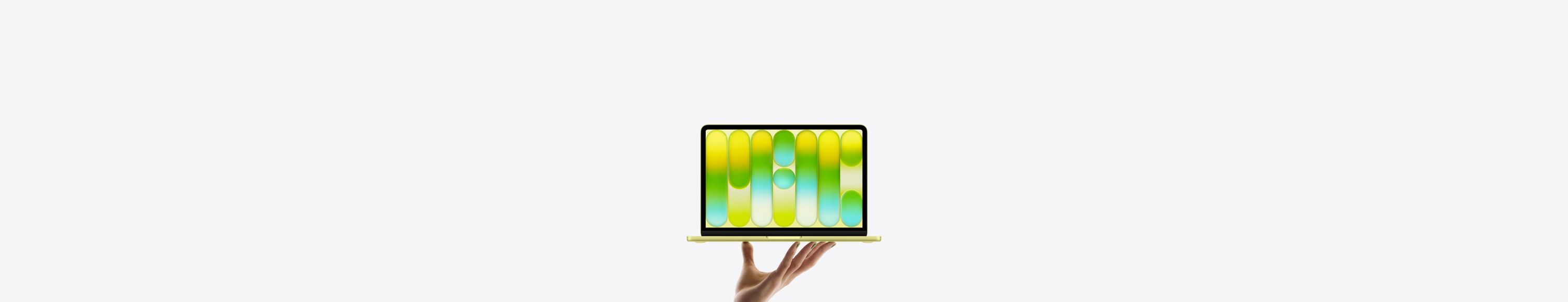 MacBook Neo amarelo-cítrico brilhante equilibrado nas pontas dos dedos de uma mão aberta. A tela mostra um padrão abstrato colorido